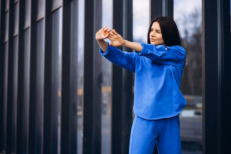 Person doing a fluid yoga pose in a calm, minimalist environment.